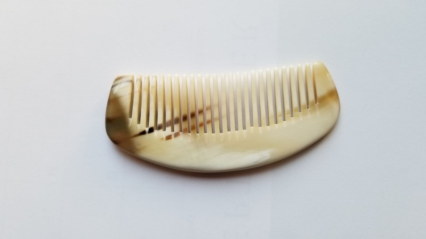 Petite yak horn comb flat lay, cream-ivory horn with natural amber stripe, pocket-sized 3.5 inch comb for fine and short hair
