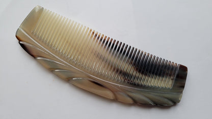 Vintage style brown and white comb with a curved shape and a decorative design. The comb is made of horn.  Great gift for men and comes with a gift bag.