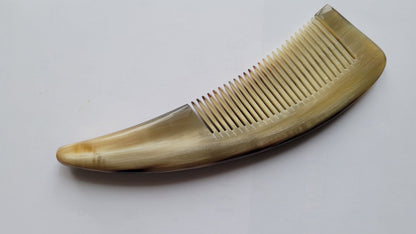 Natural yak horn comb with ergonomic curved handle, warm olive-amber grain, hand-polished fine teeth for snag-free combing