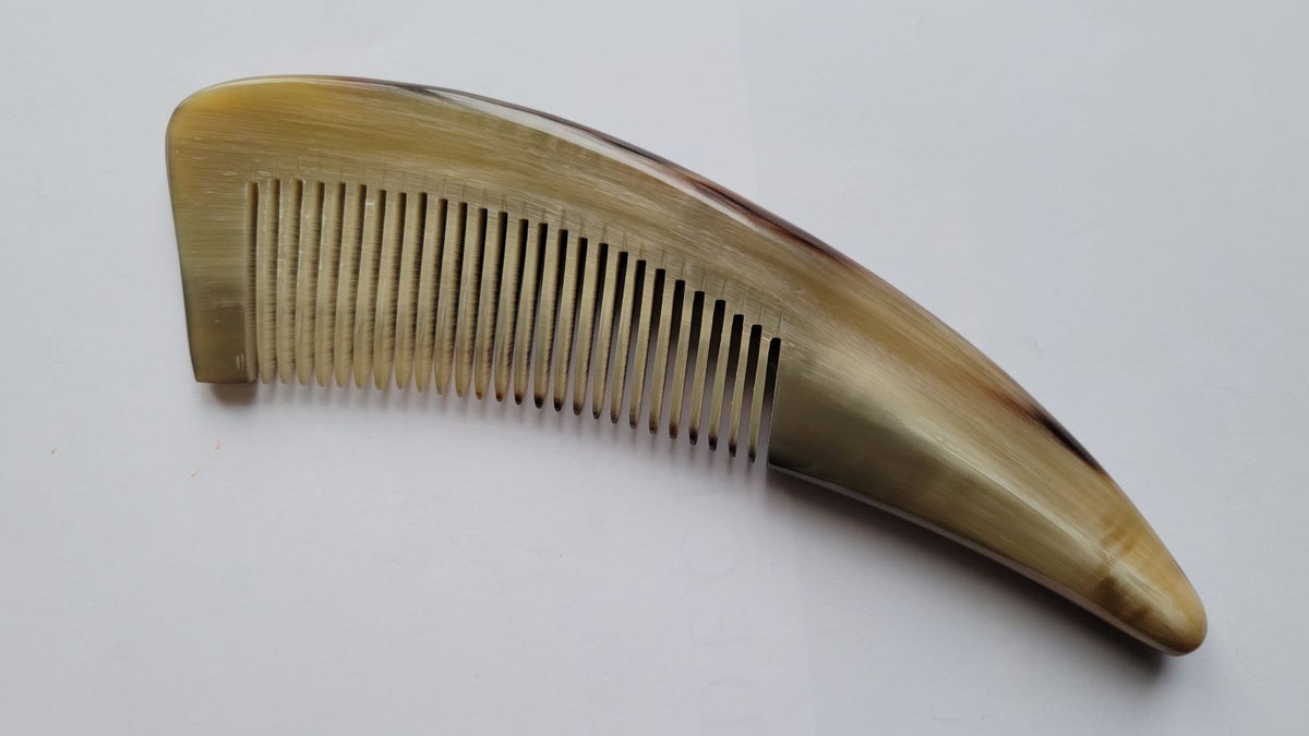 Fine tooth yak horn comb with 0.12 cm spacing, pale golden horn, curved handle for comfortable grip, anti-static beard and hair comb