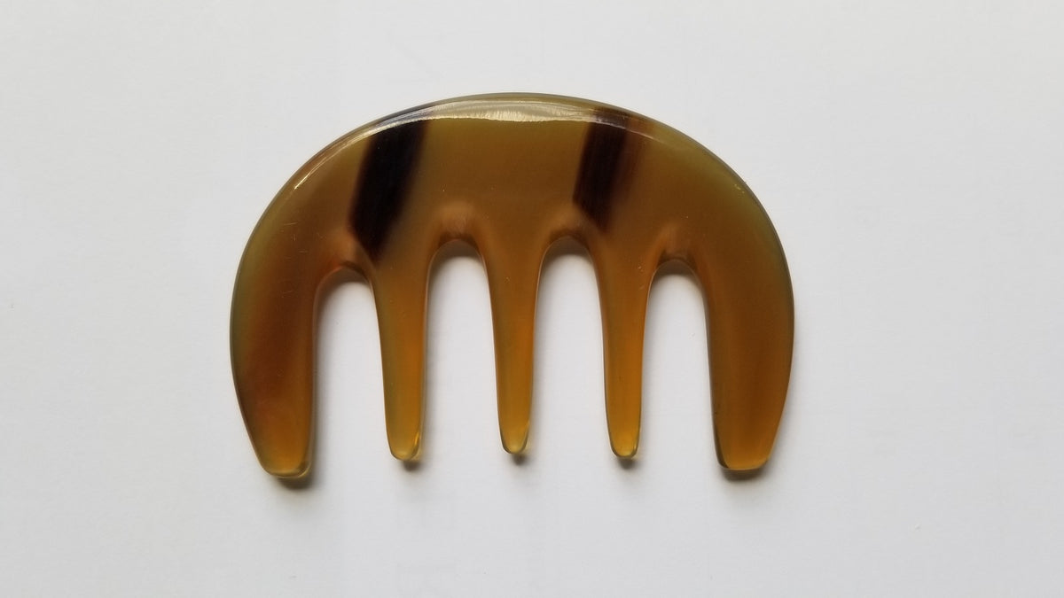 Yak horn glider comb with five extra wide teeth, flat lay front view — amber and dark honey natural horn — Arakicrafts