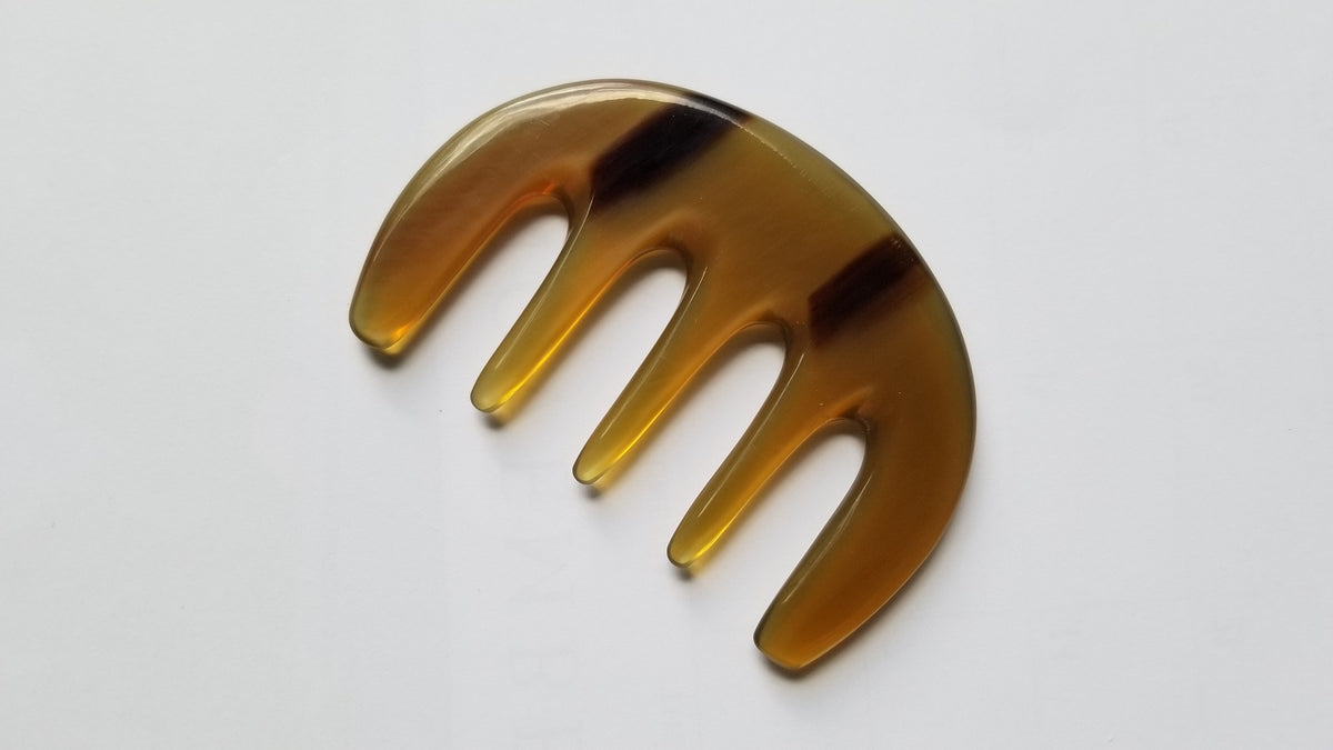 Yak horn glider comb used as scalp massager — five rounded teeth for tension relief and circulation — Arakicrafts